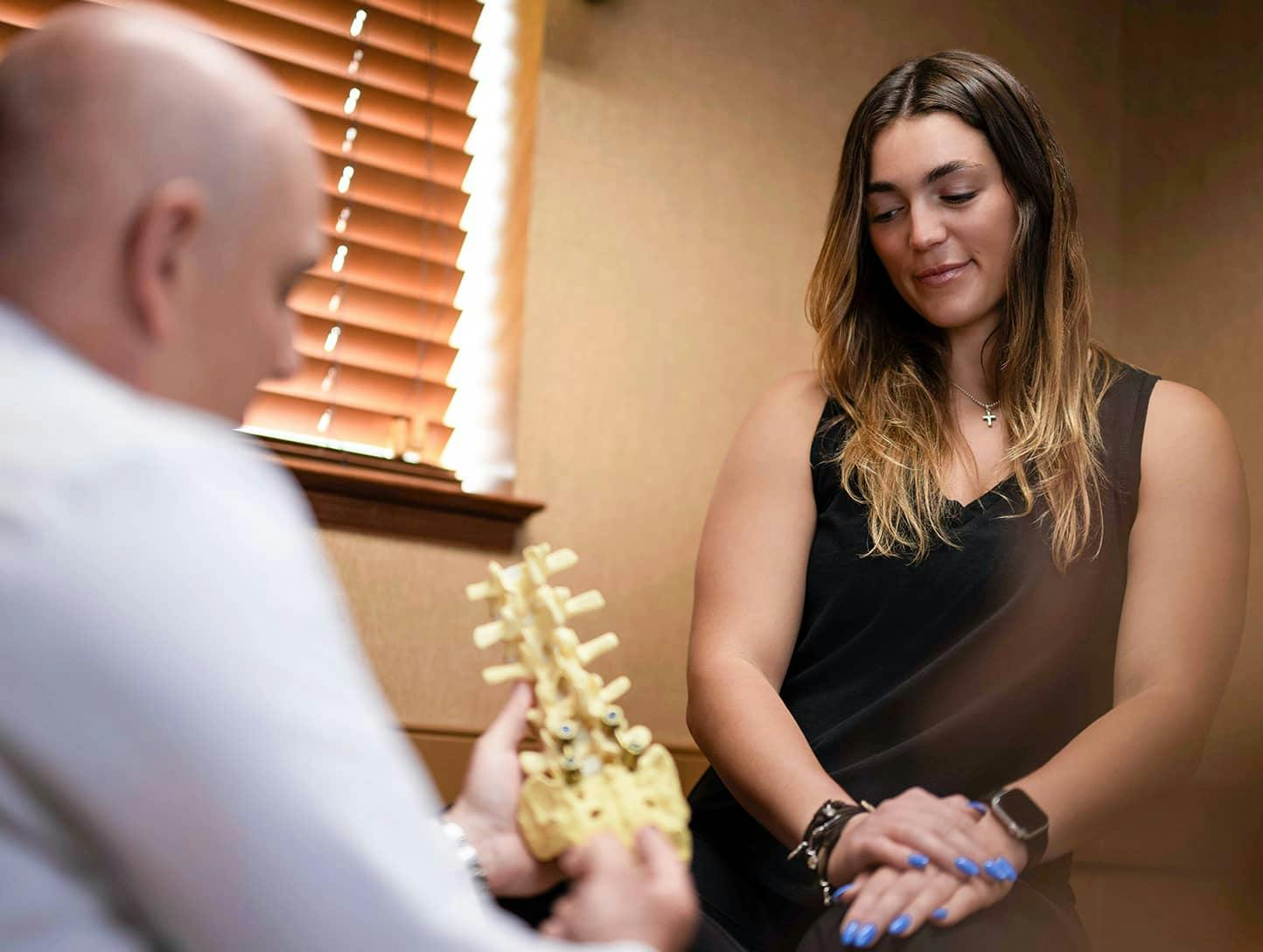Woman looking at Spine Anatomical Model