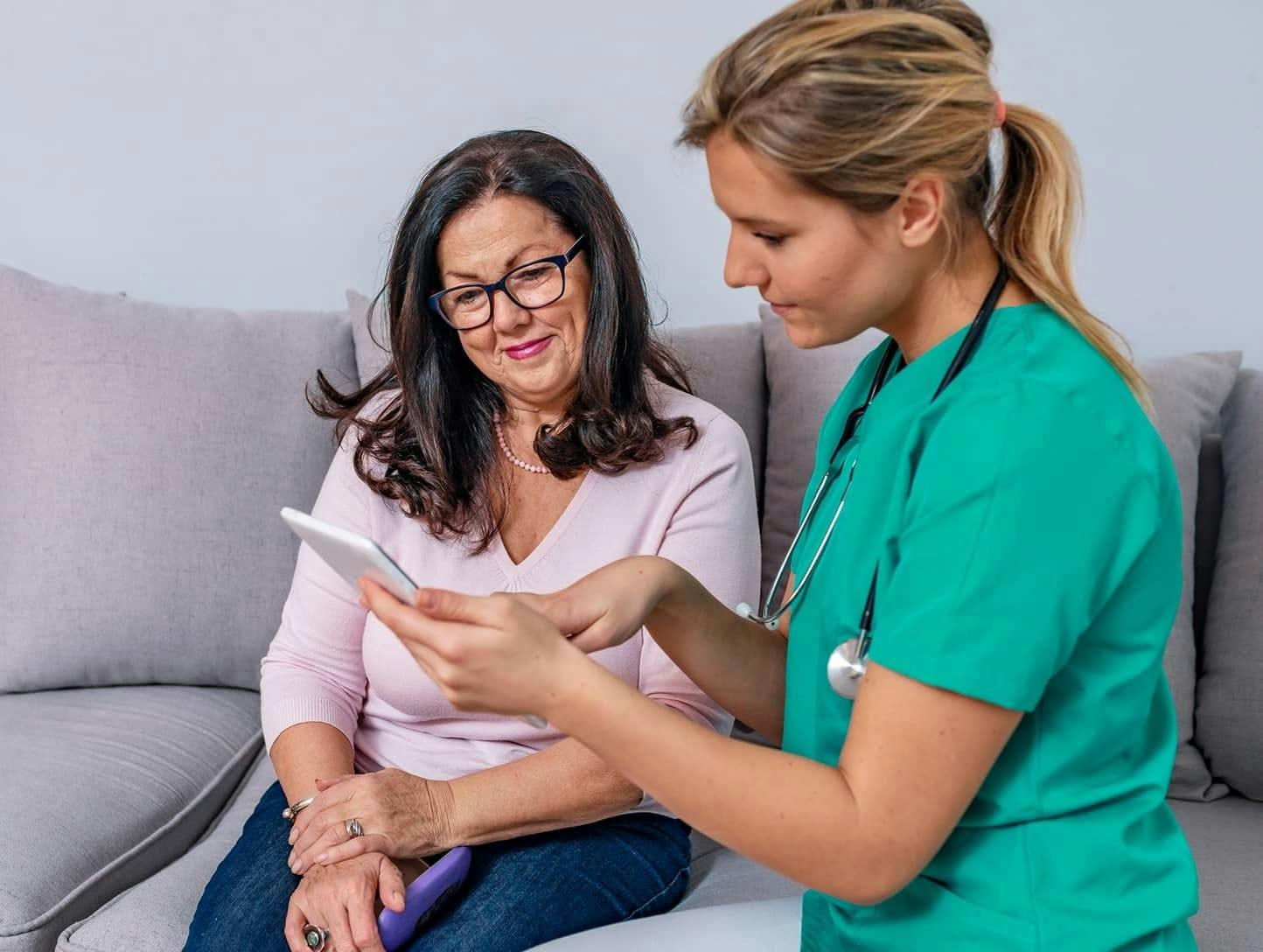 Courtney Brennan showing patient something on tablet