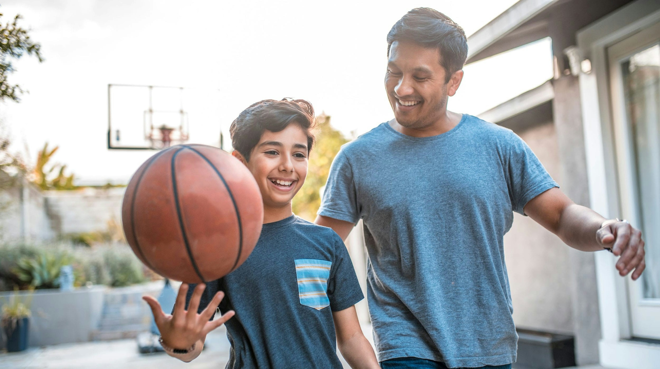 father and son playing basket ball