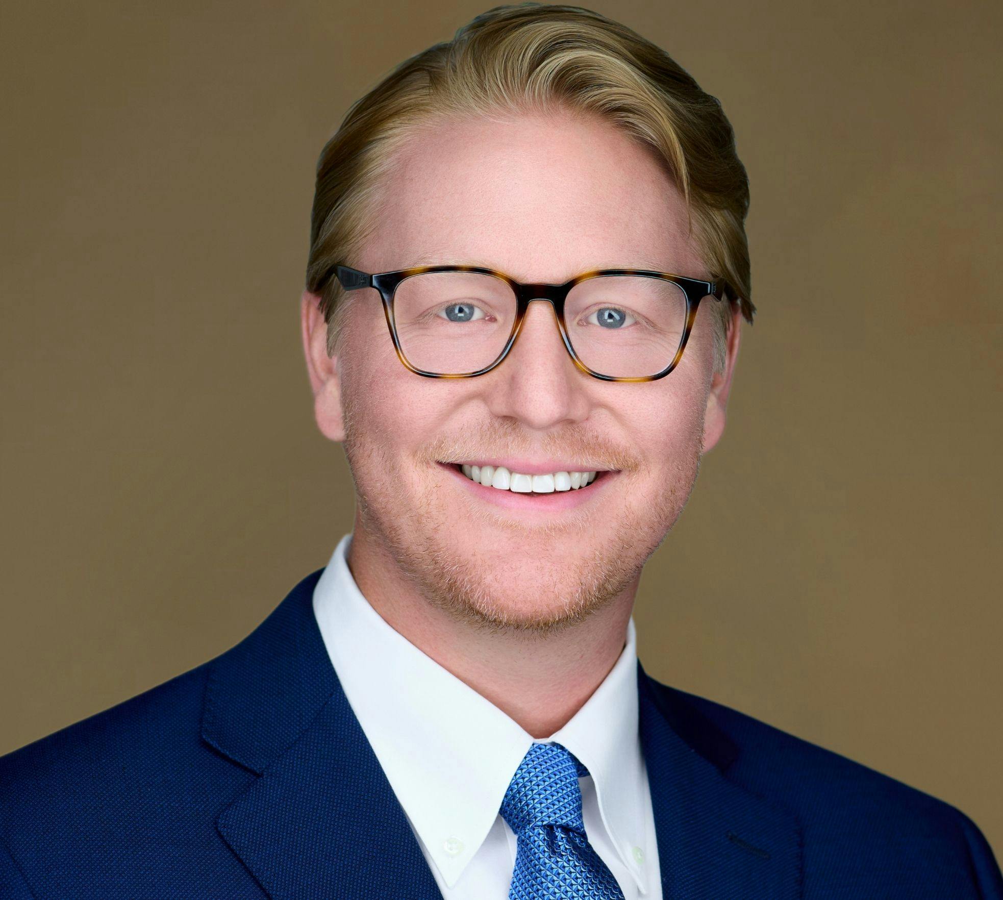 Dr. Kerrigan smiling in suit