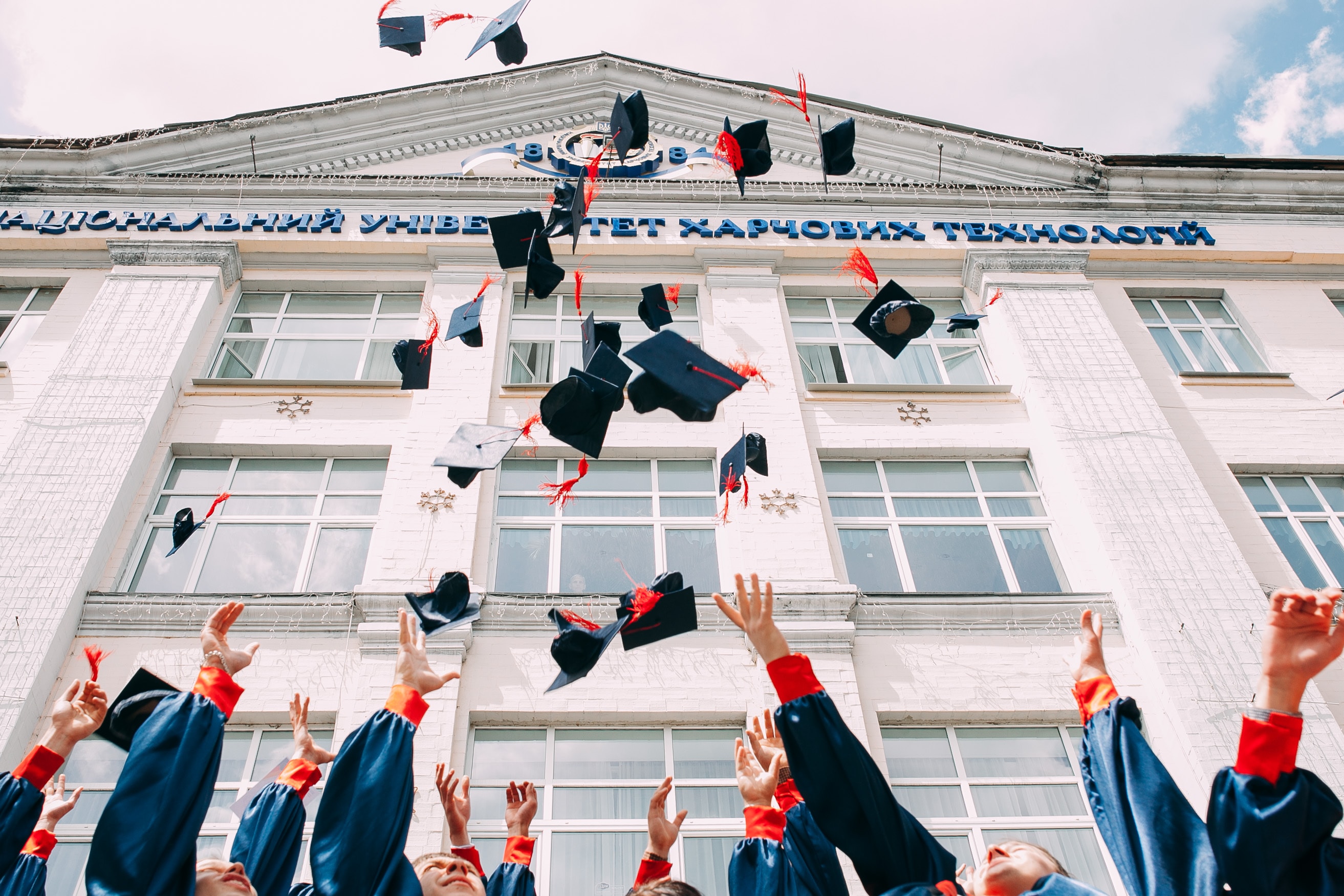 graduates throwing their hats