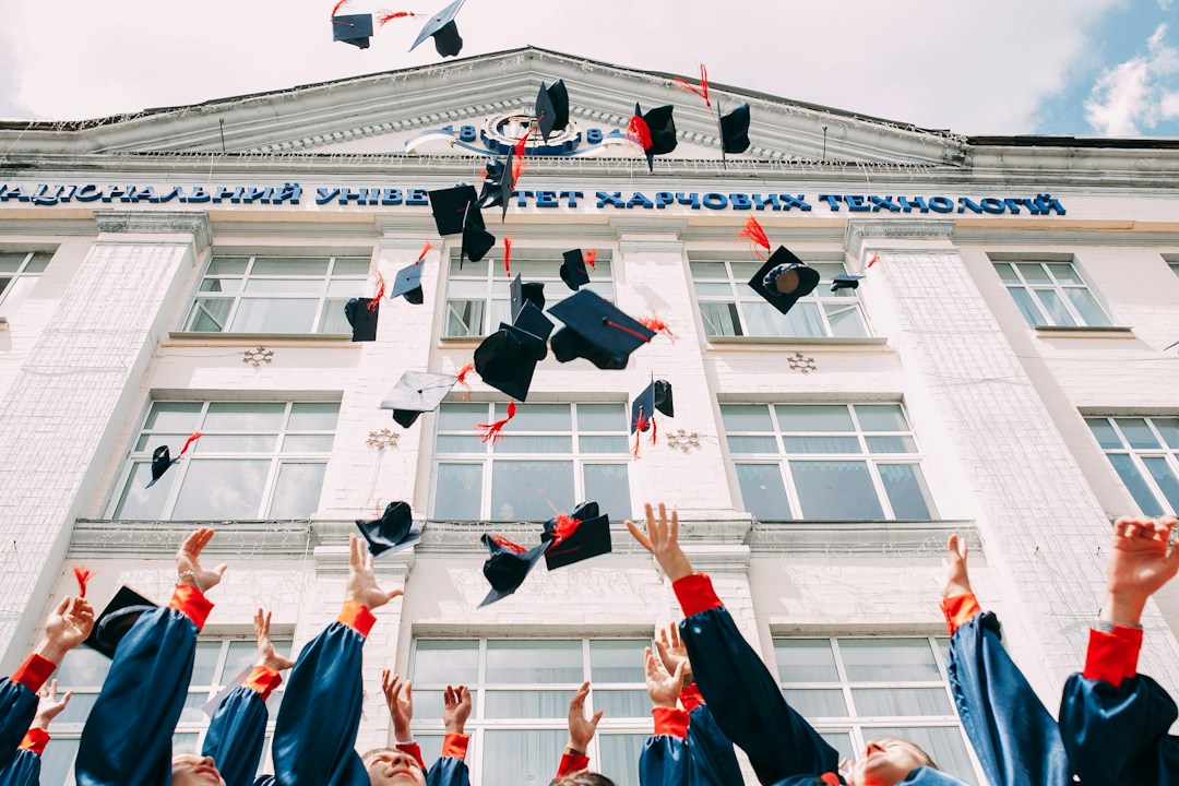 graduates throwing their hats