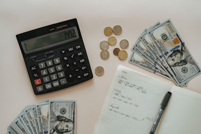 calculator, money and a notebook