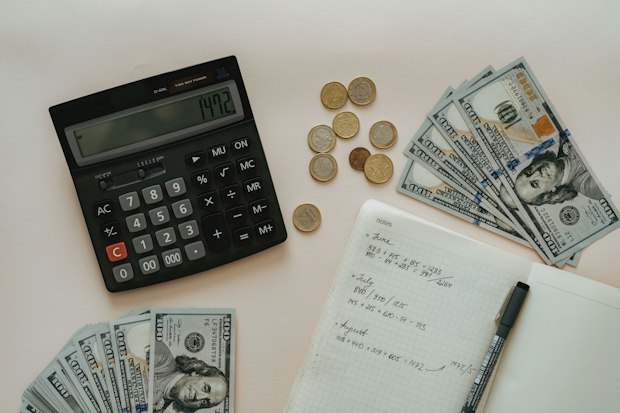 calculator, money and a notebook