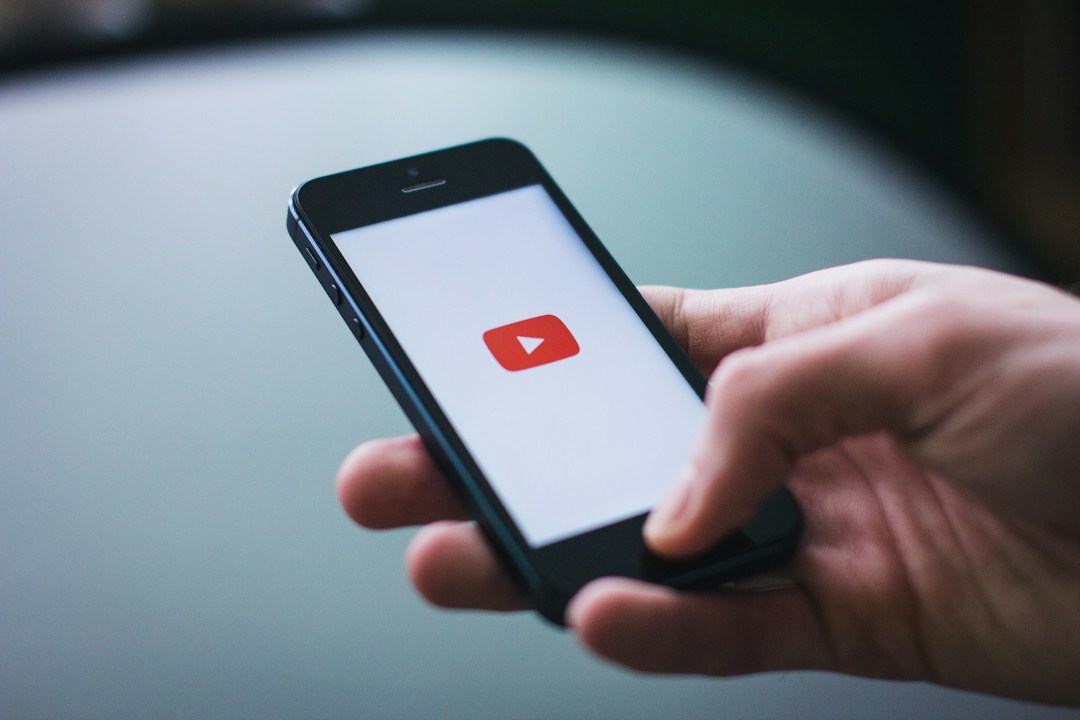 man using YouTube on his smartphone