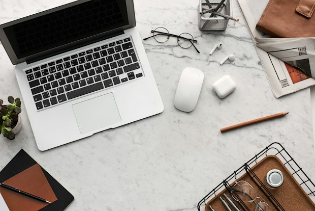 grey laptop on grey desk