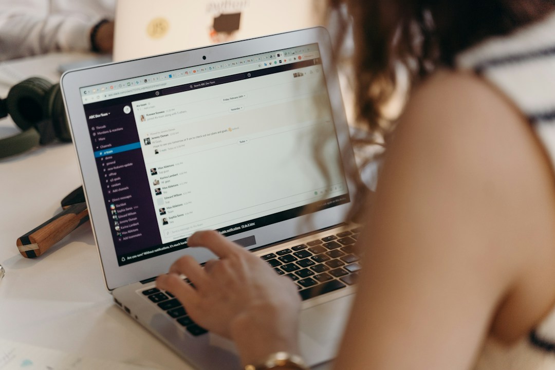 Young woman working on a grey laptop