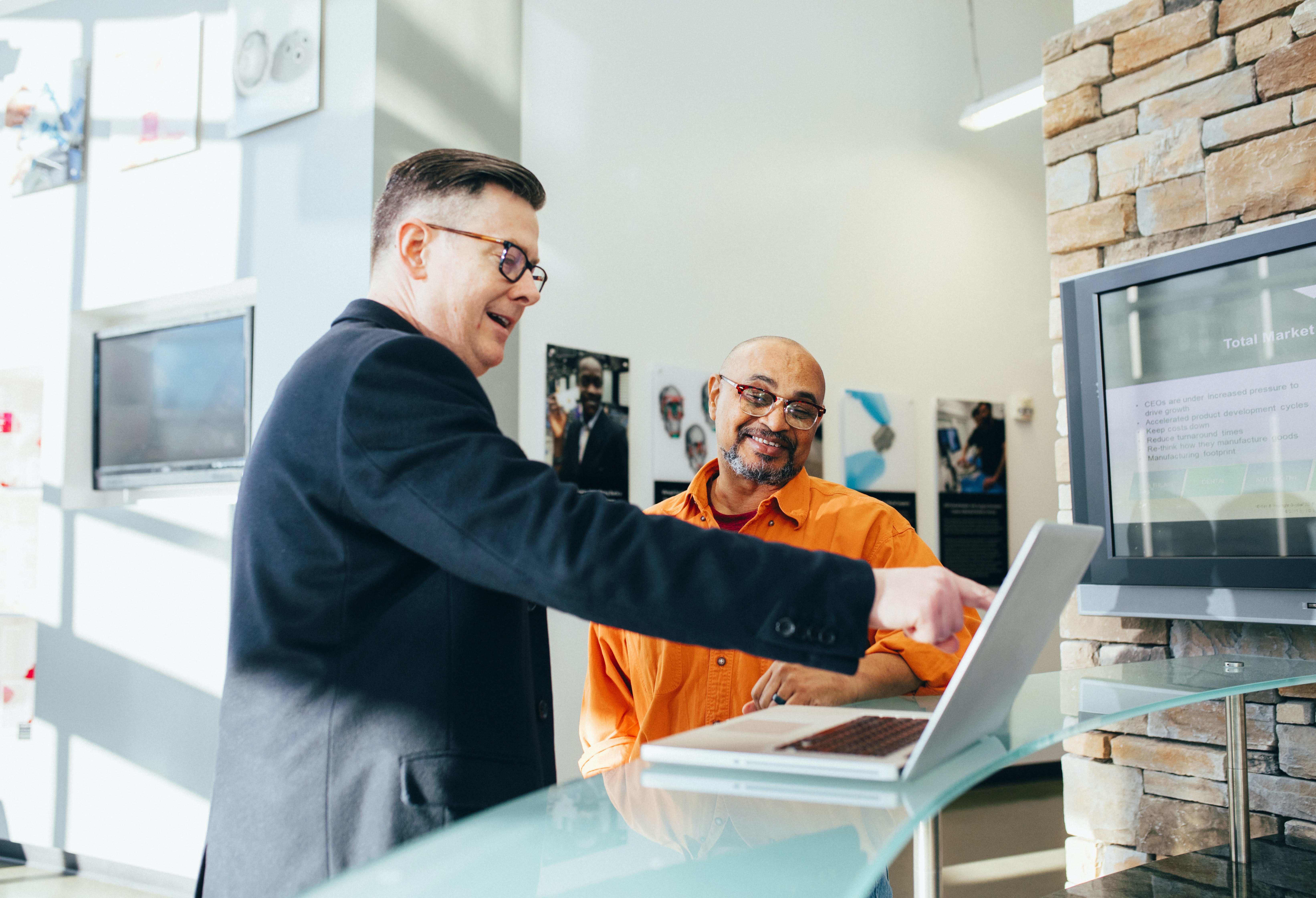 Two men working on a laptop