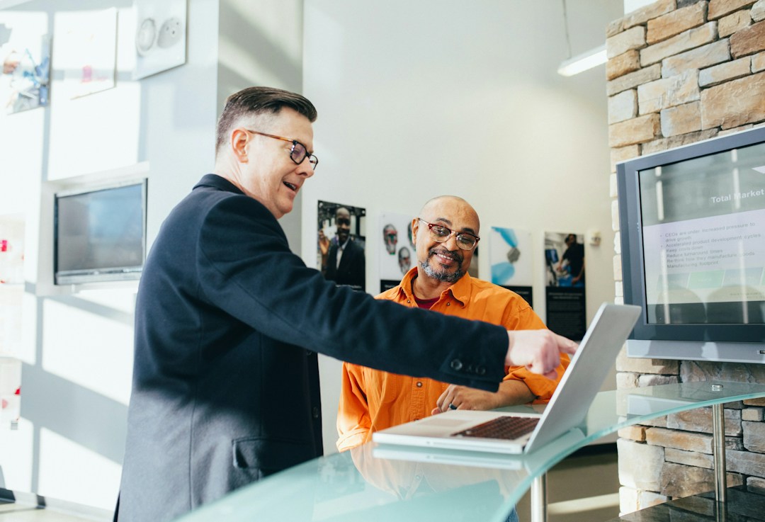 Two men working on a laptop