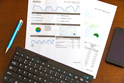 Printed graphs next to a black keyboard