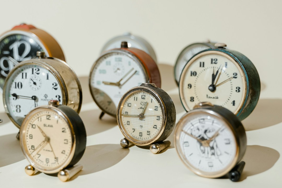 small clocks arranged on a beige background