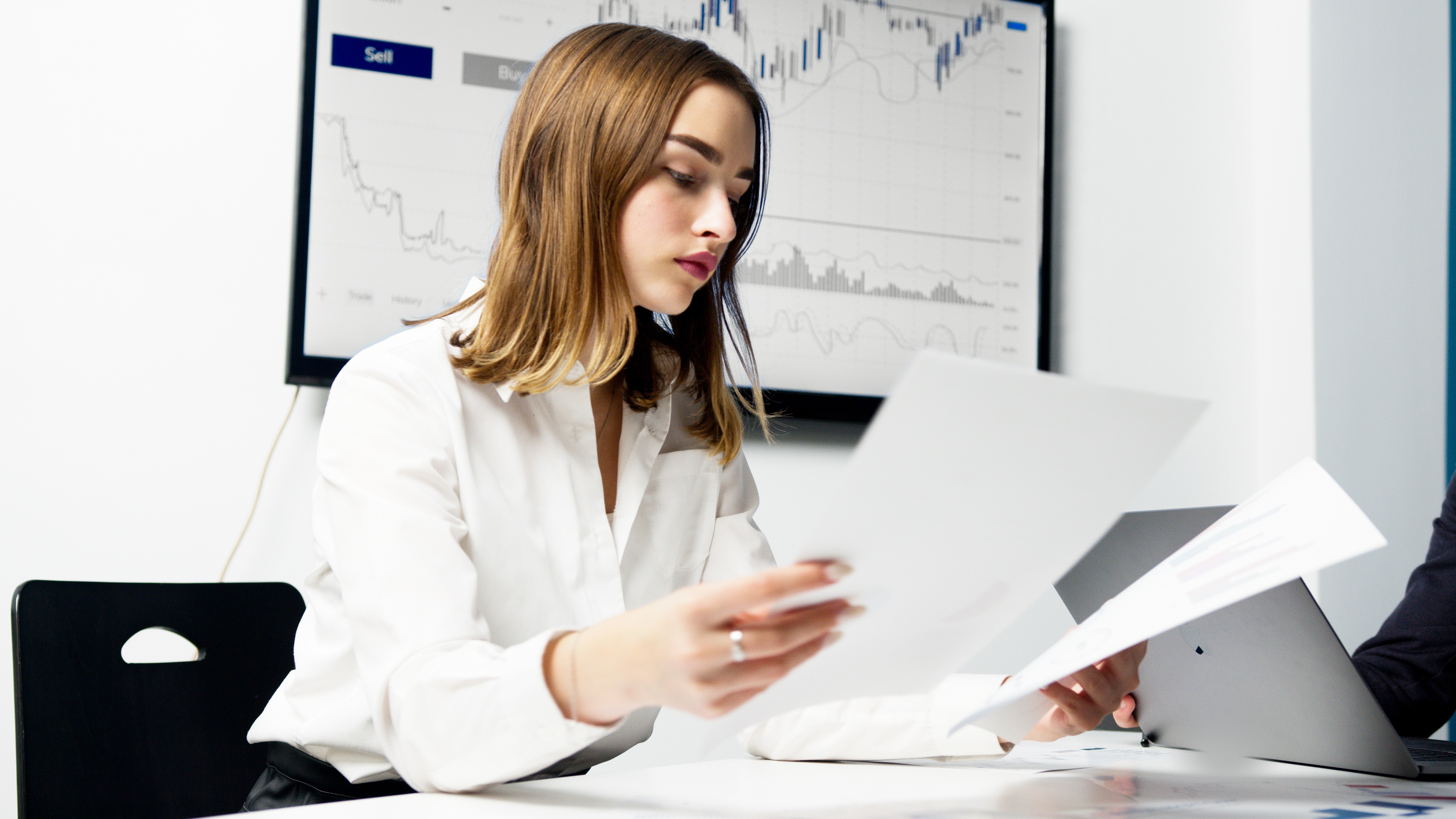 woman reading documents at a desk