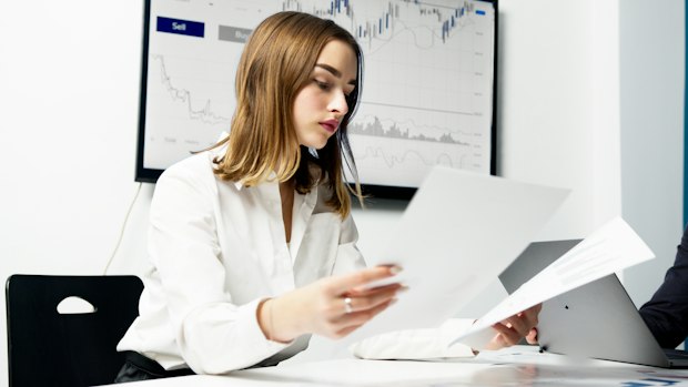 woman reading documents at a desk