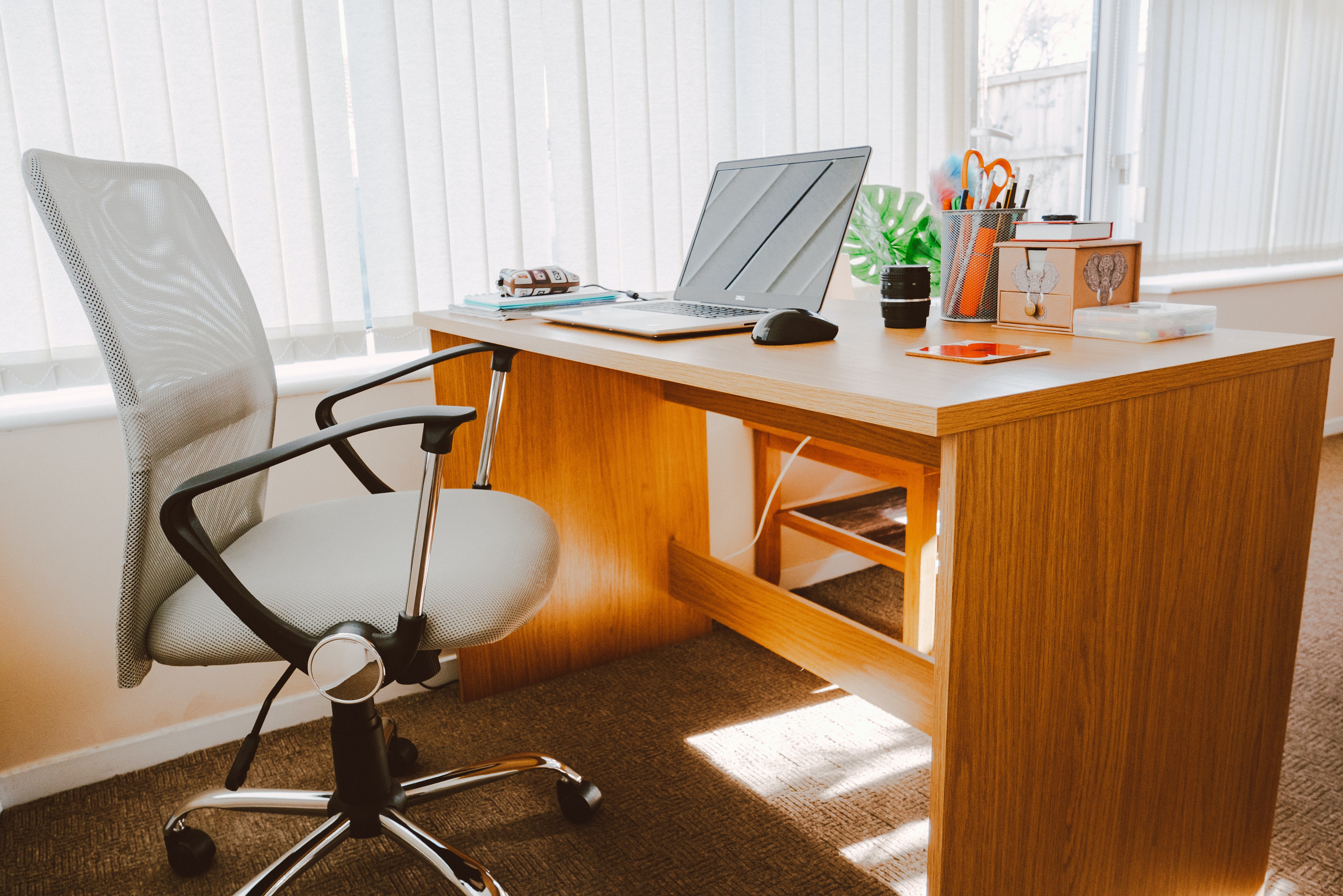 white office chair next to brown wooden work from home desk