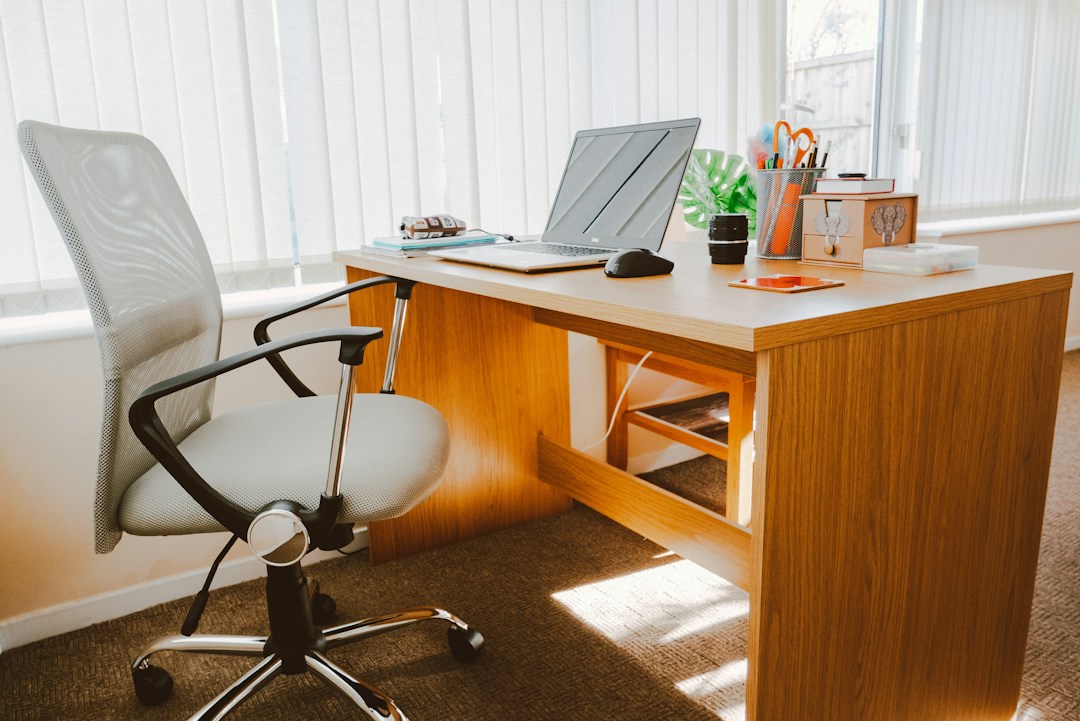 white office chair next to brown wooden work from home desk