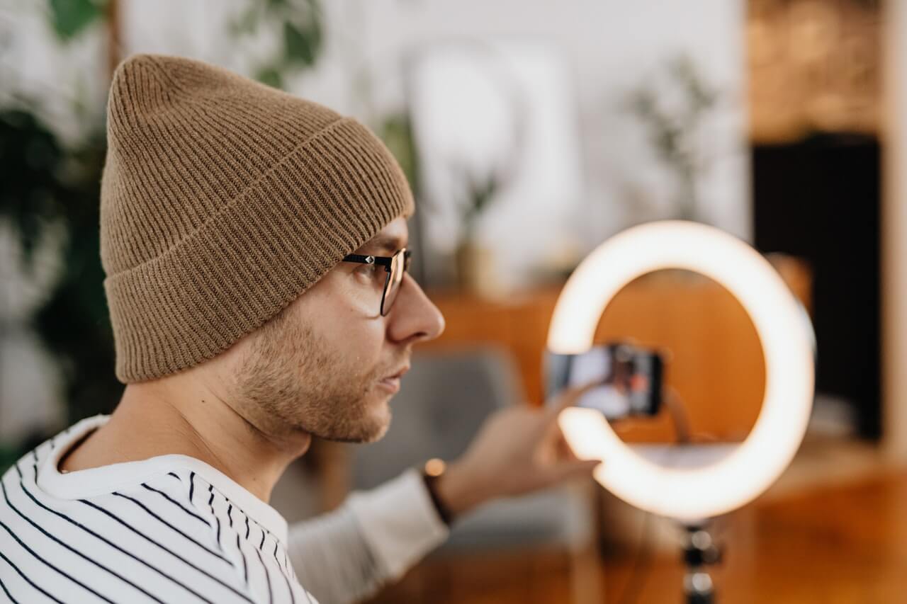 Man setting up lighting for video conference