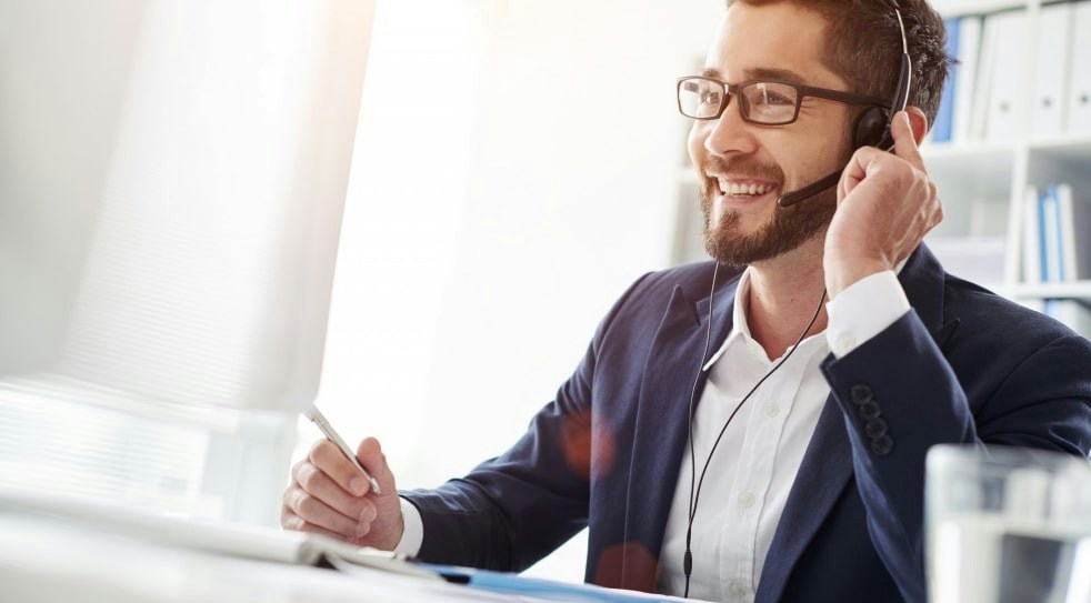 External communication: a salesperson wearing a headset on a customer call