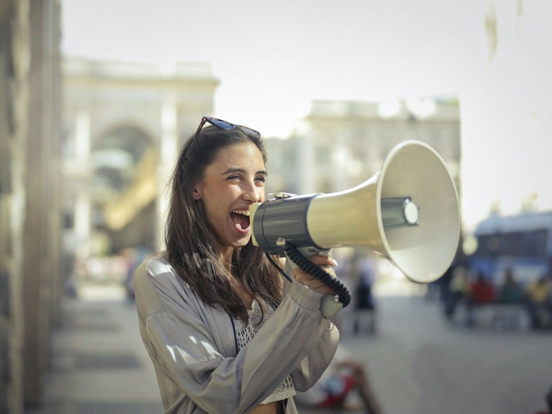 woman with megaphone communication in the workplace