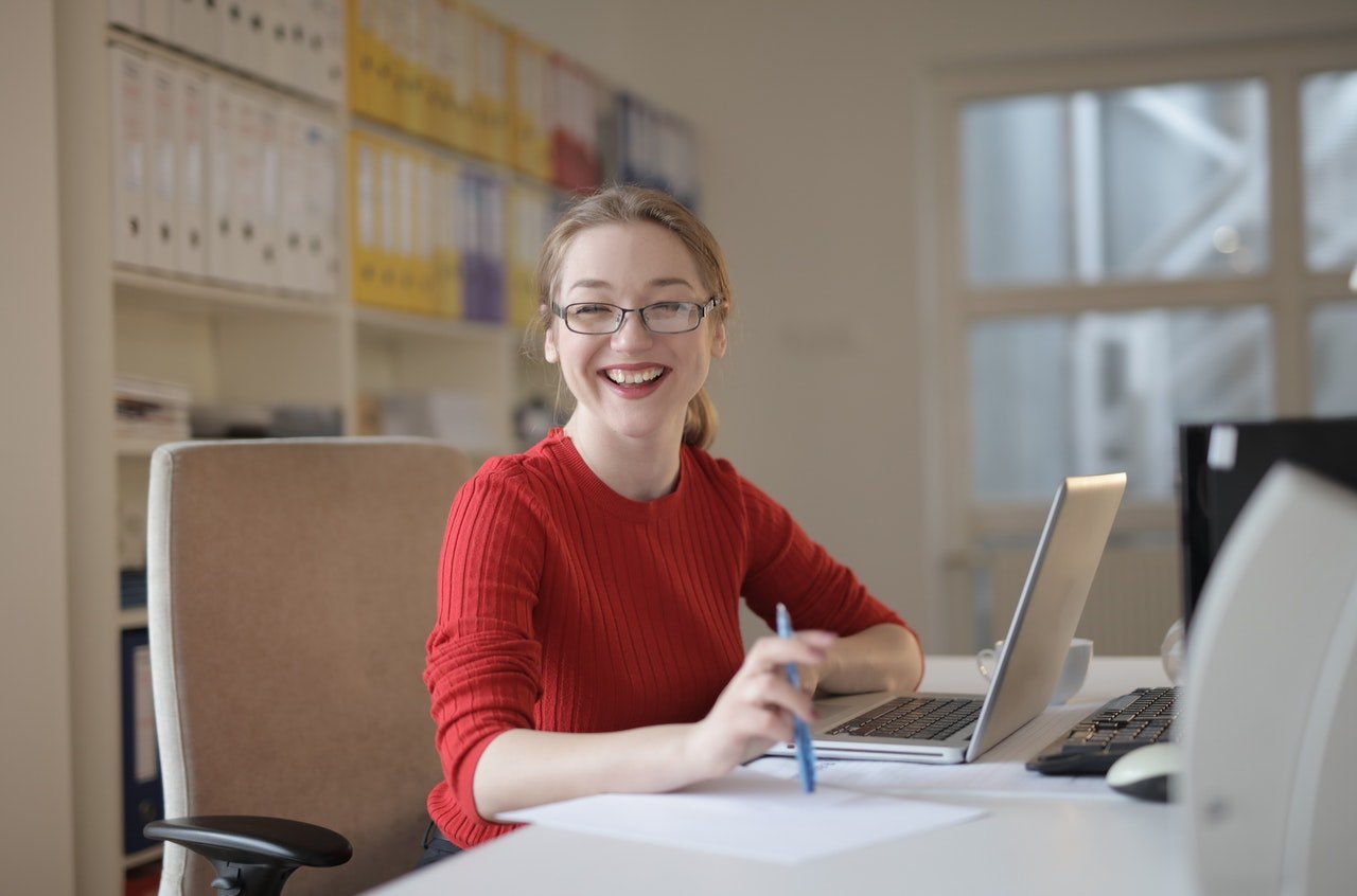 webinar presenter smiling at desk