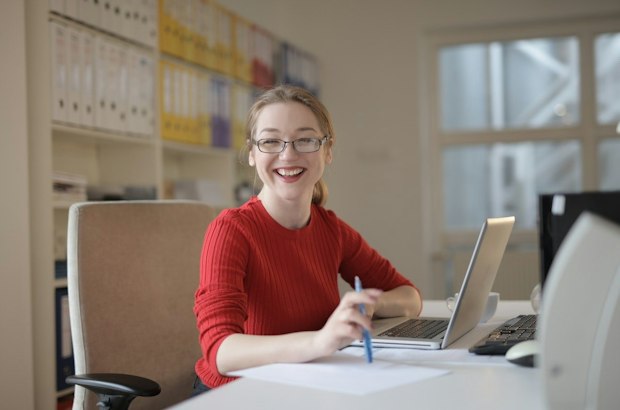 webinar presenter smiling at desk
