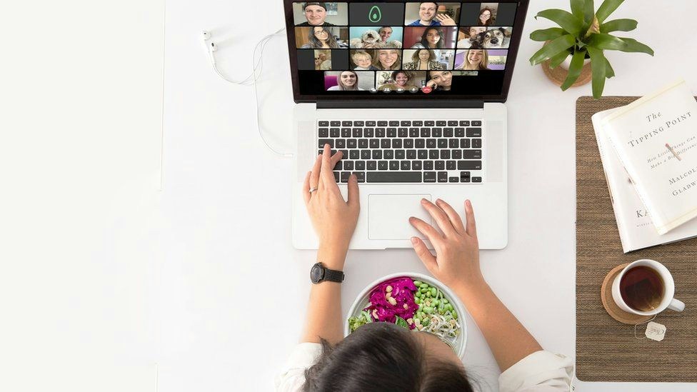An employee attending a virtual lunch and learn session remotely