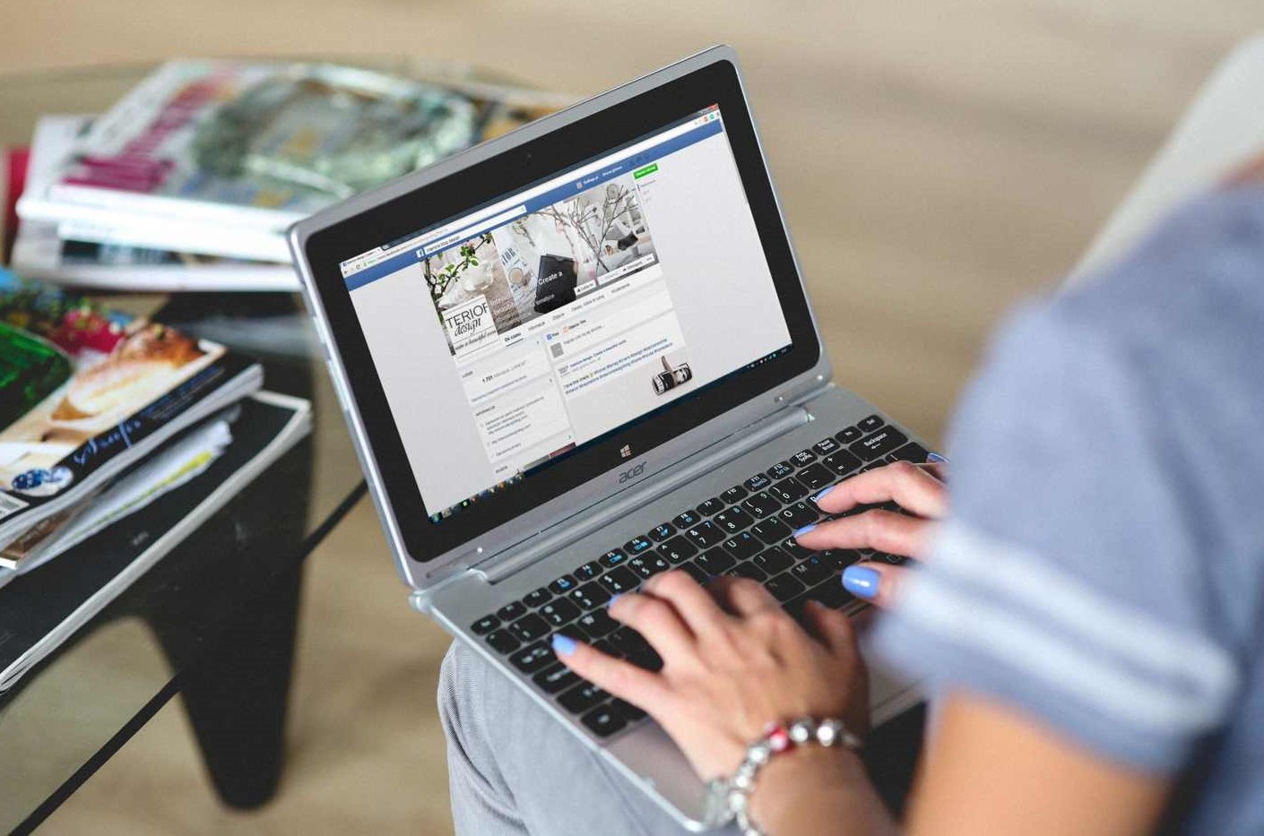 Woman using Facebook on a laptop