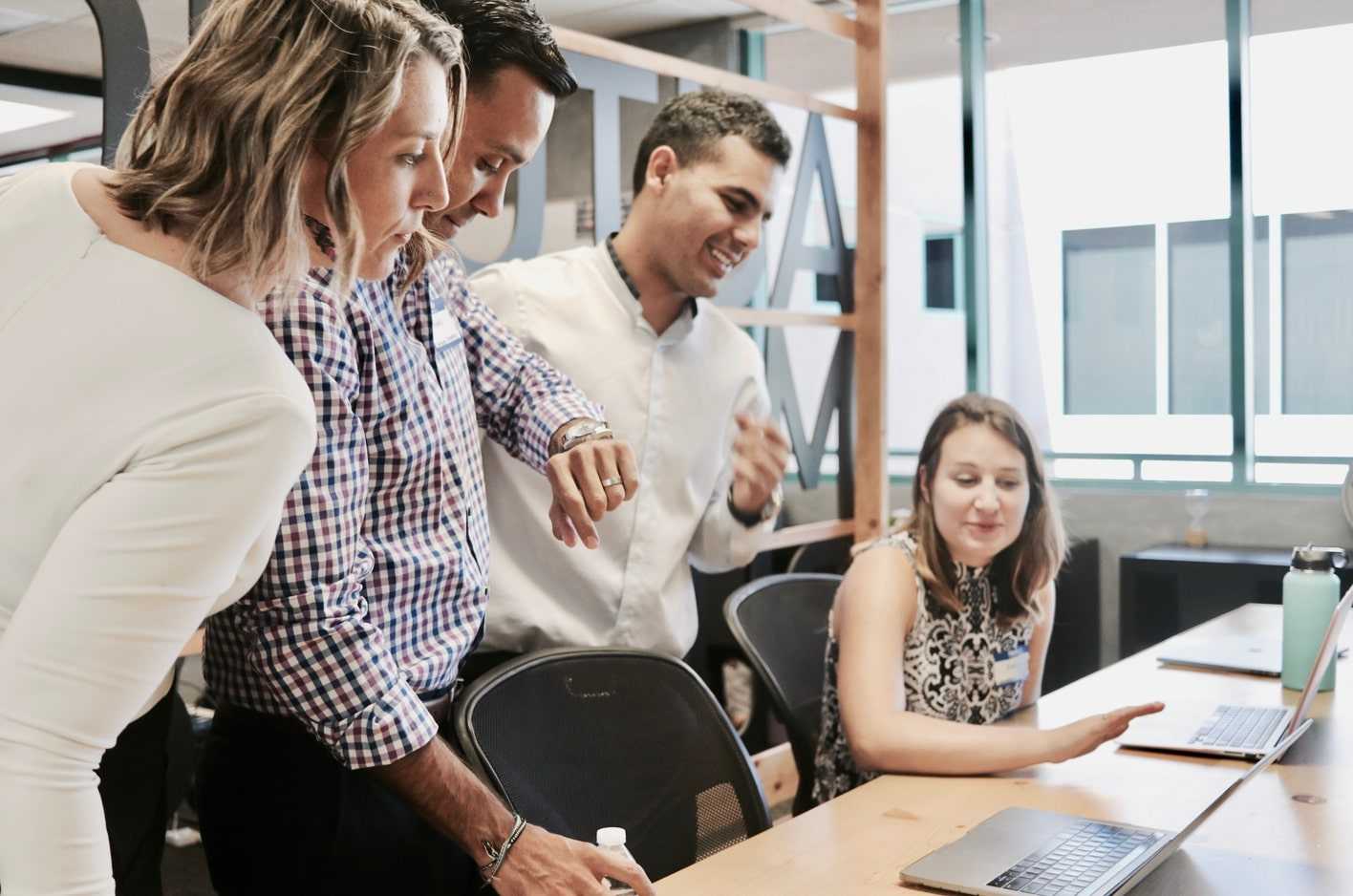 Employees gathering for a daily team stand-up meeting