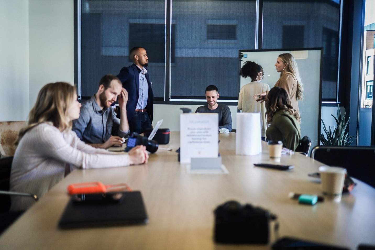 People speaking in a weekly stand-up meeting