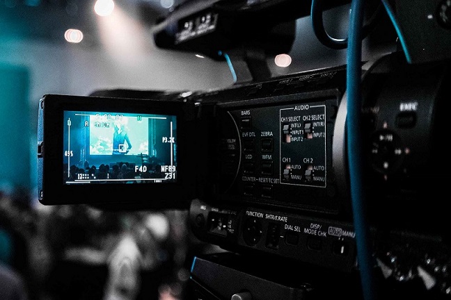 Video camera recording a live event for hybrid event marketing