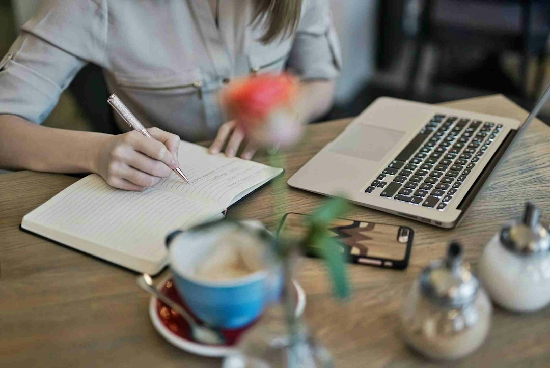 Woman taking notes on a notebook in a productive meeting