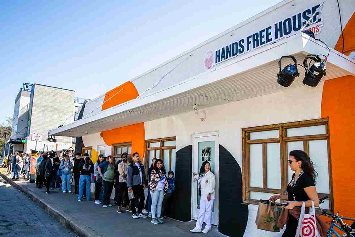 People queuing up outside the experiential pop-up marketing event Cheetos Hands Free House