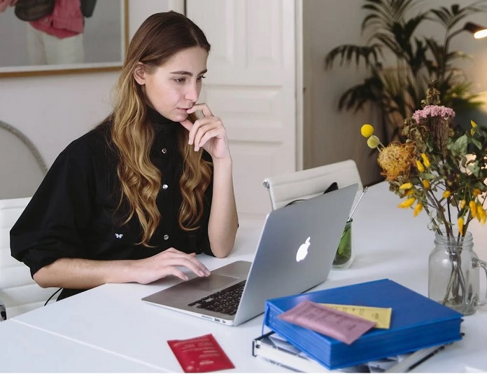 Woman sitting on a chair watching a webinar on her laptop Source: Image by Polina Zimmerman on Pexels.com