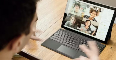 A person hosting an engaging virtual conference using a laptop