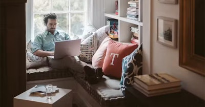 man working from home typing on a computer