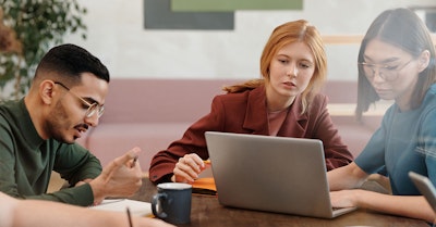 marketing team working on a laptop