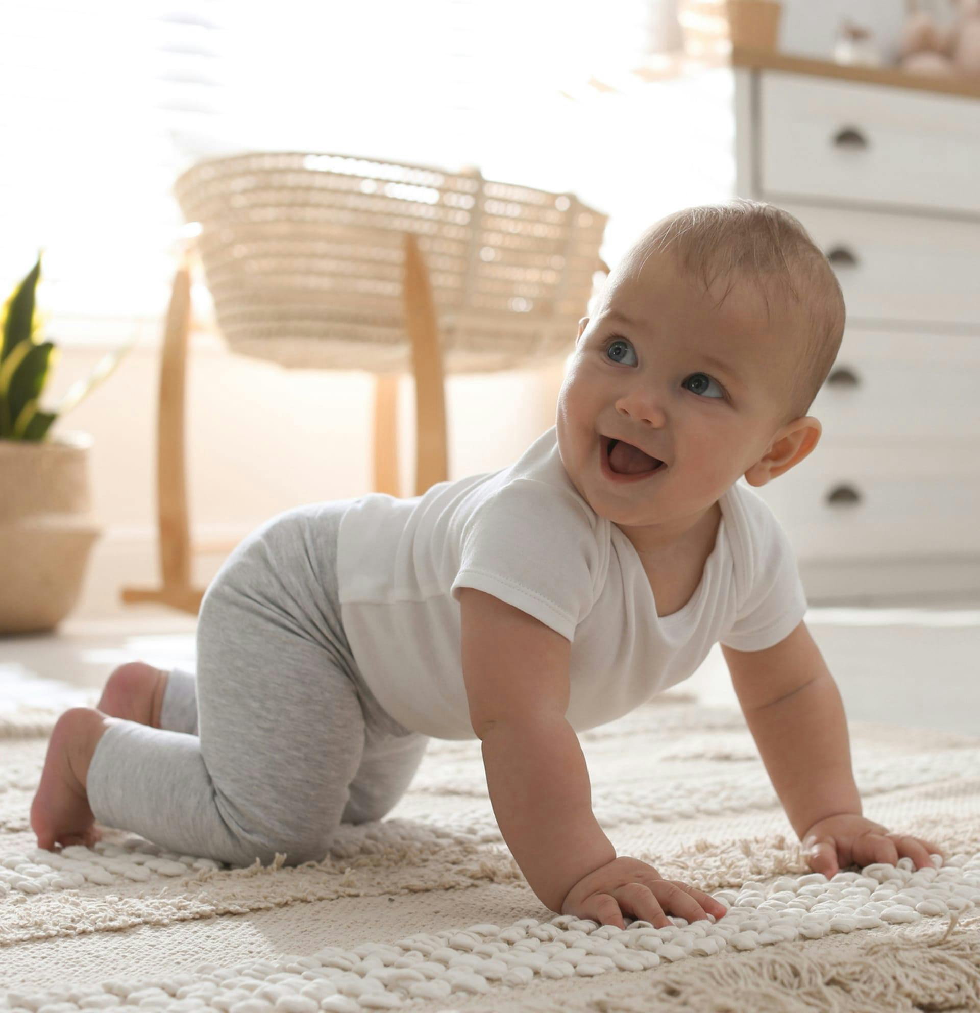smiling baby crawling on the ground