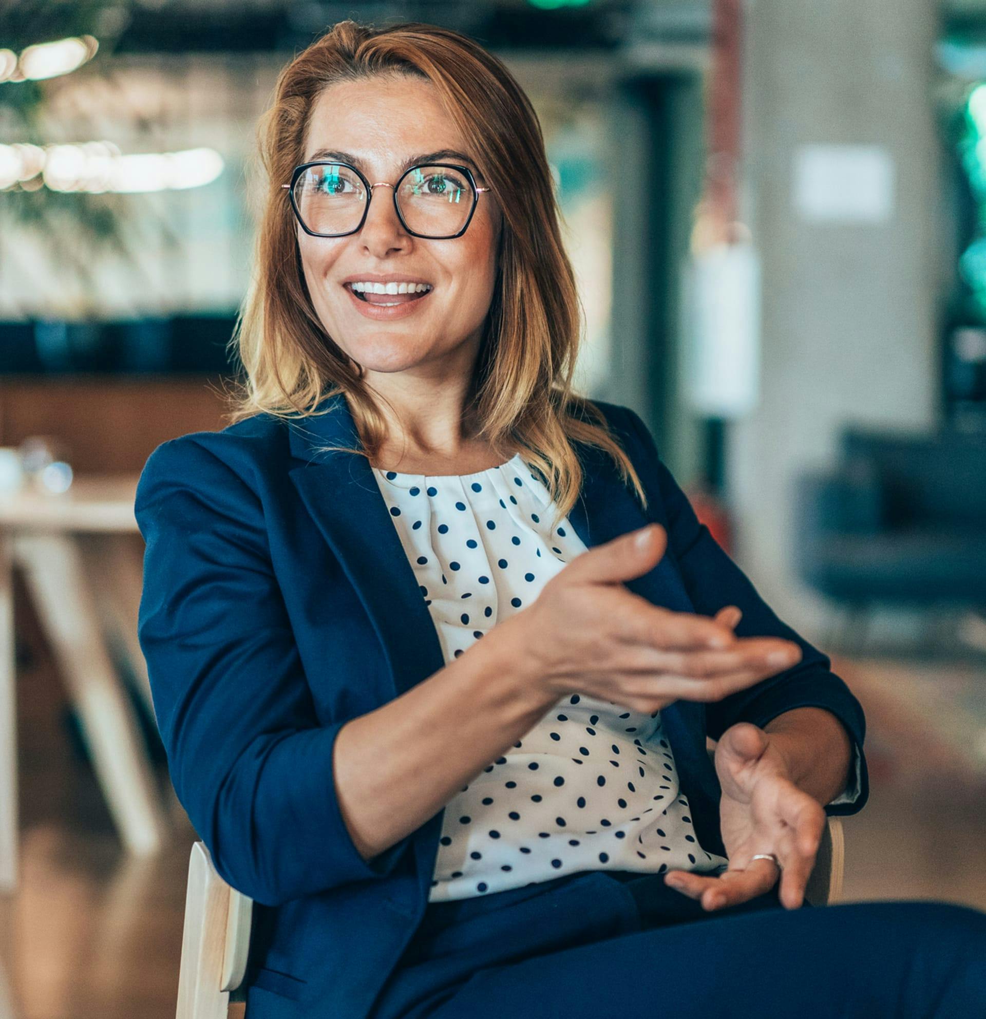 woman sitting in chair chatting with someone not pictured