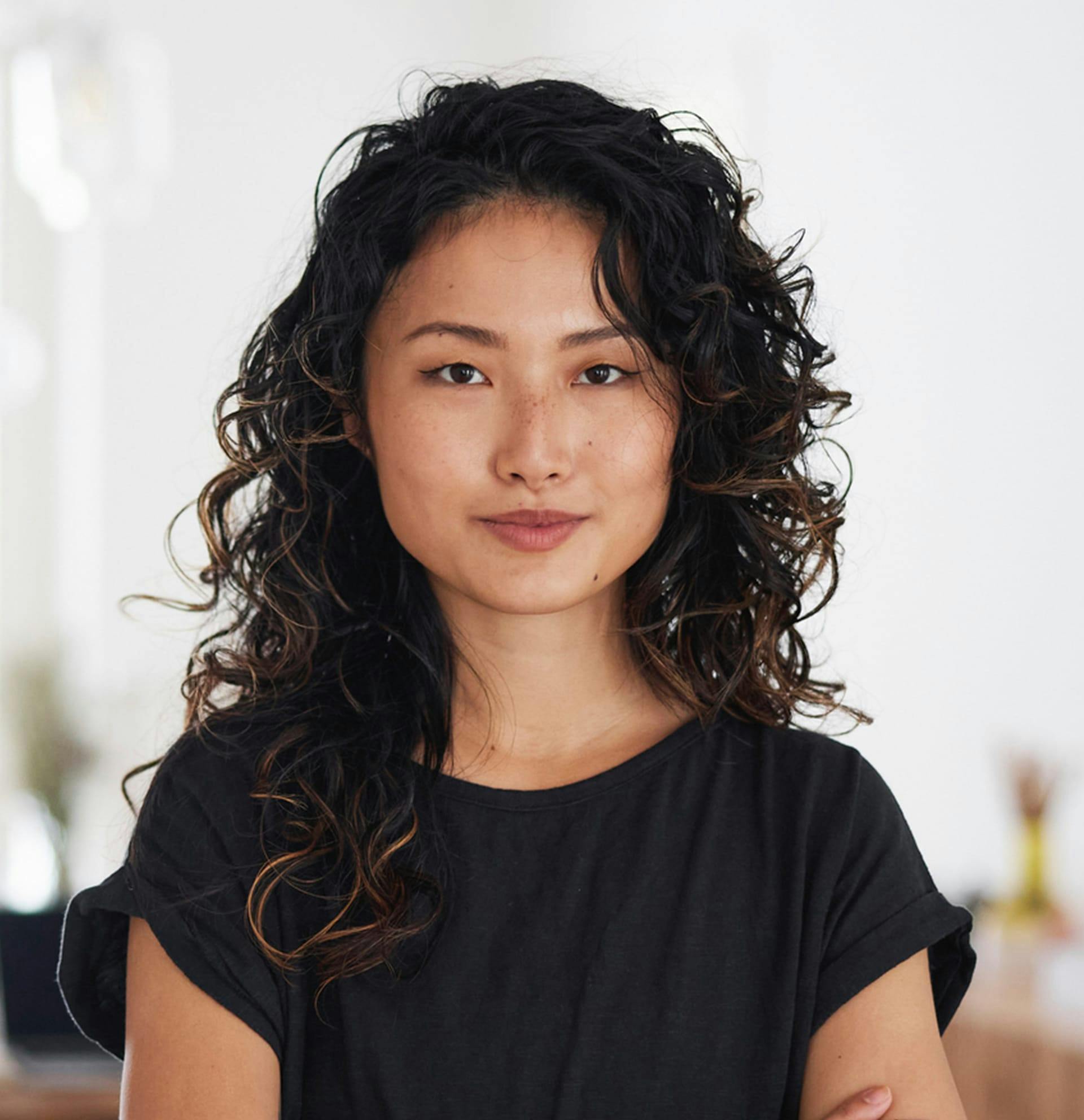woman facing camera with arms crossed