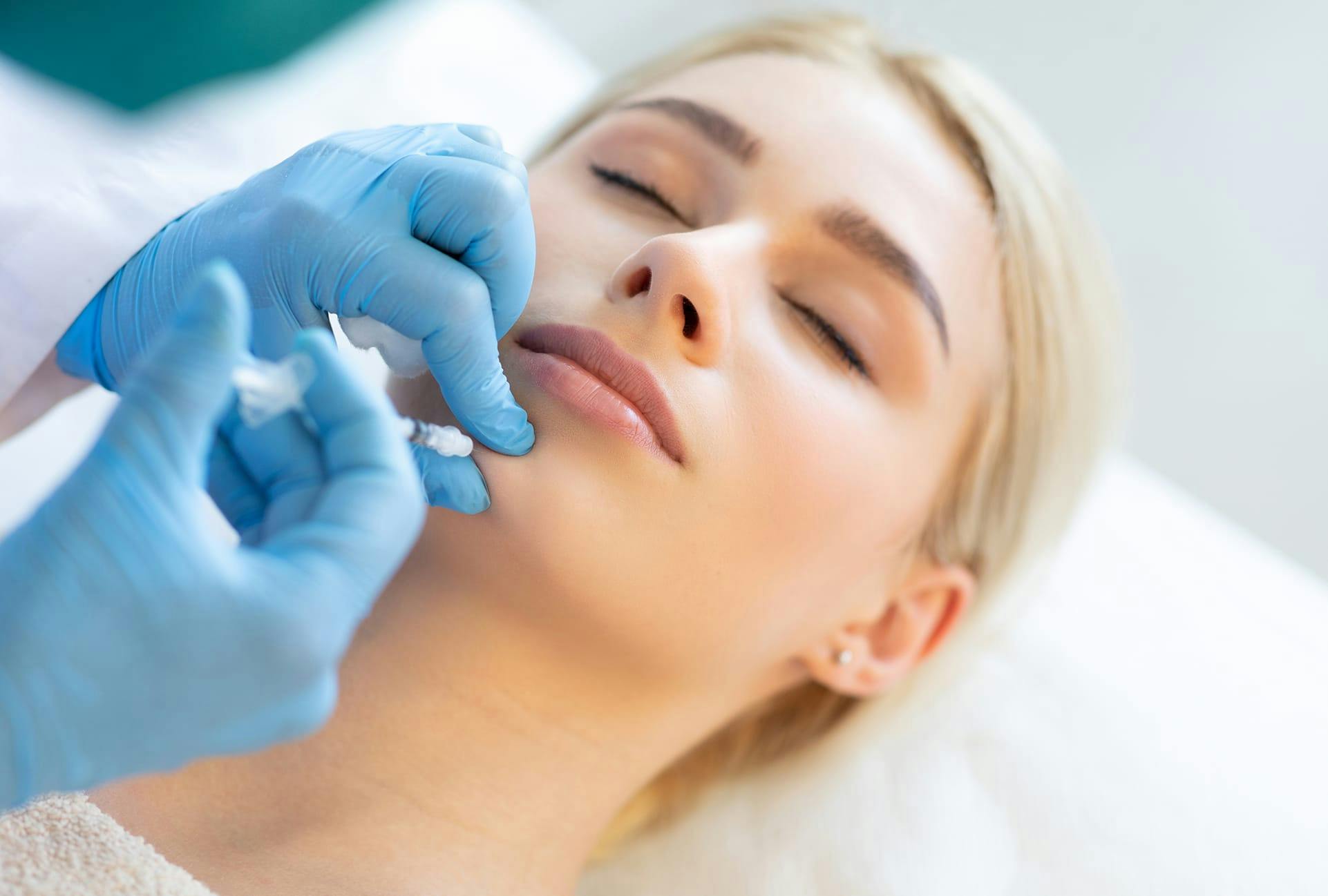 woman getting injectables on her chin