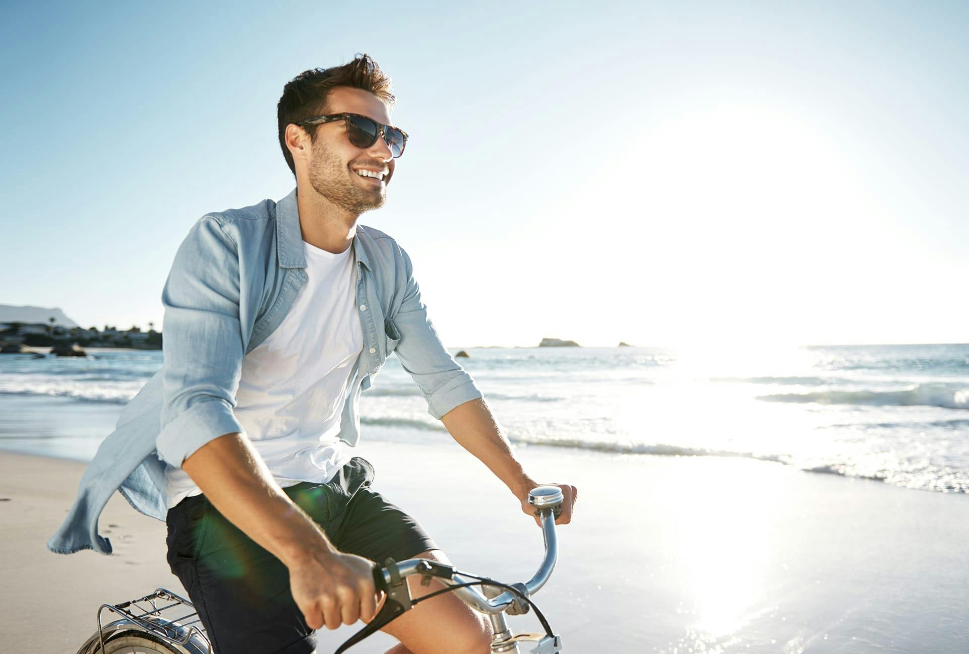 man riding bike on beach