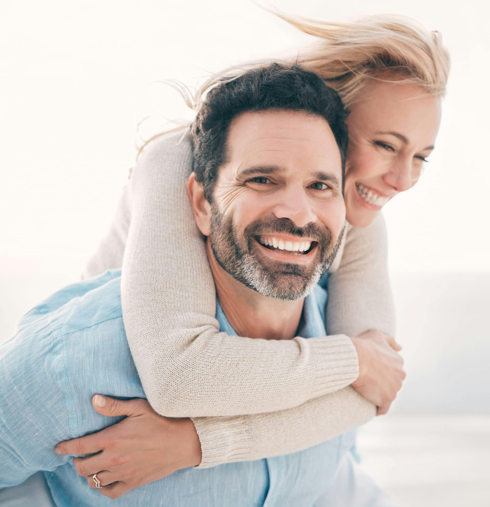 man holding woman on his back