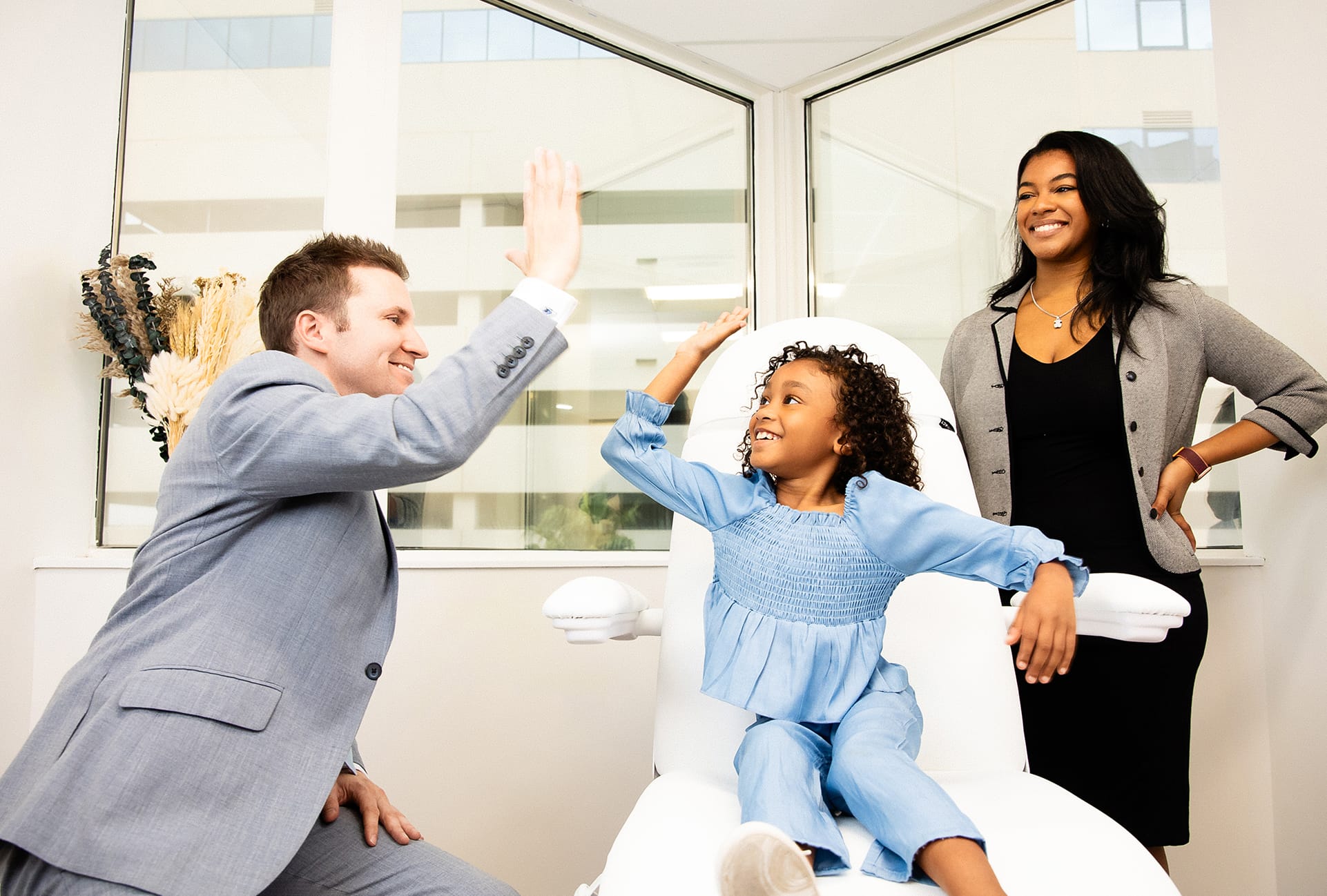 Doctor high fiving a child