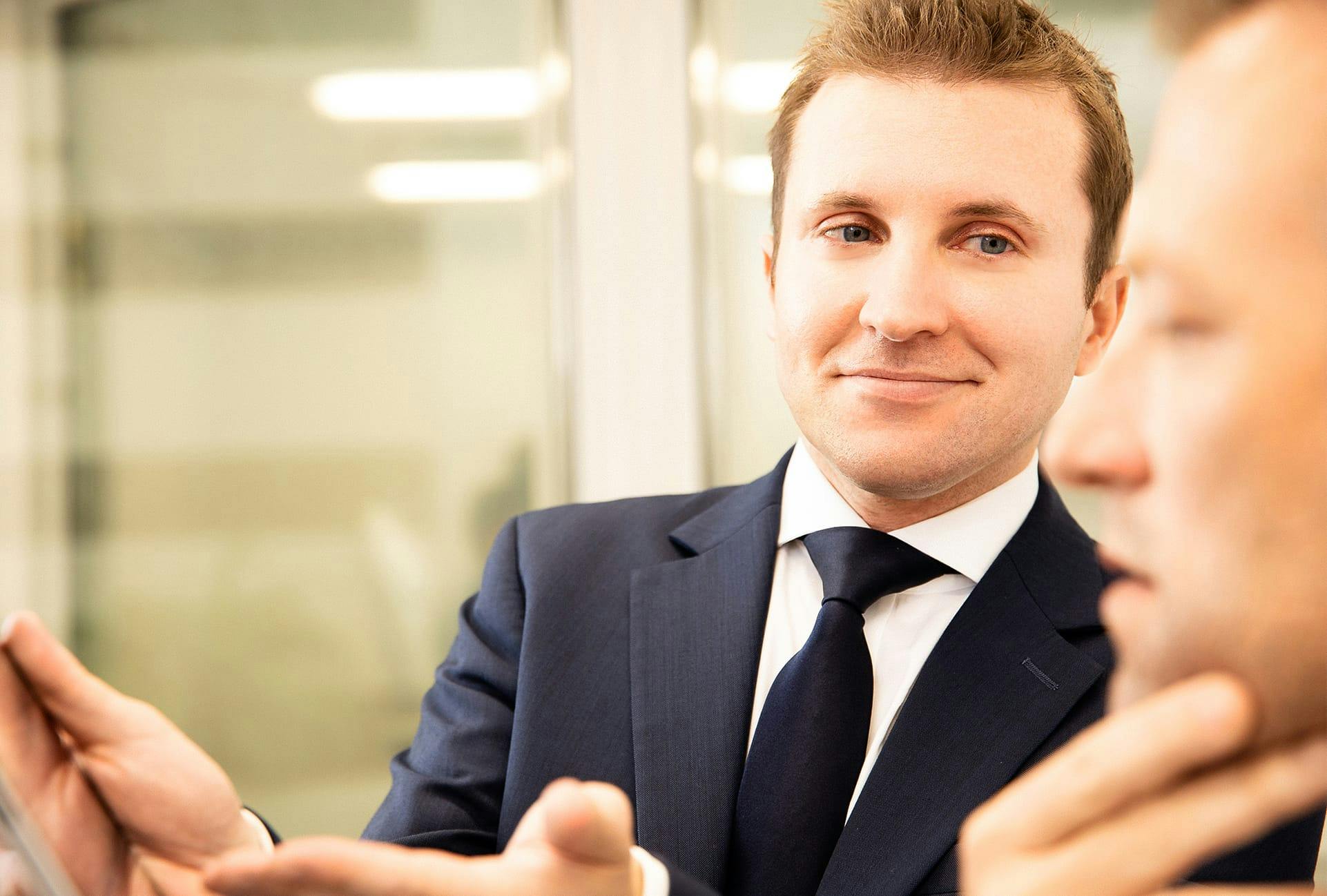 doctor holding a mirror to a man's face