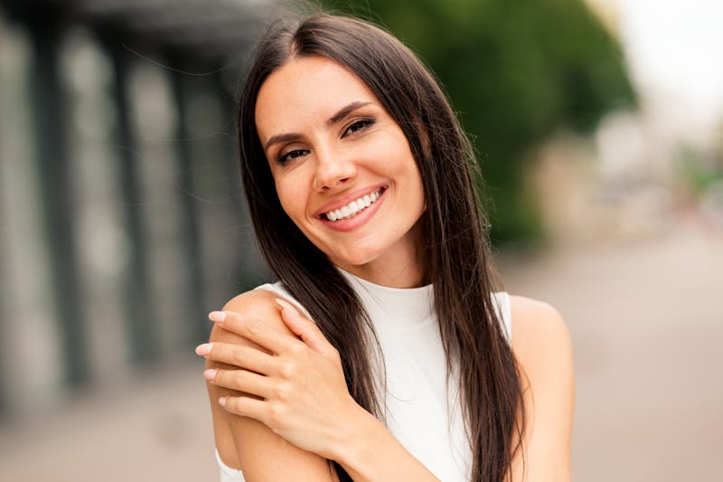 Woman with her hand on her shoulder