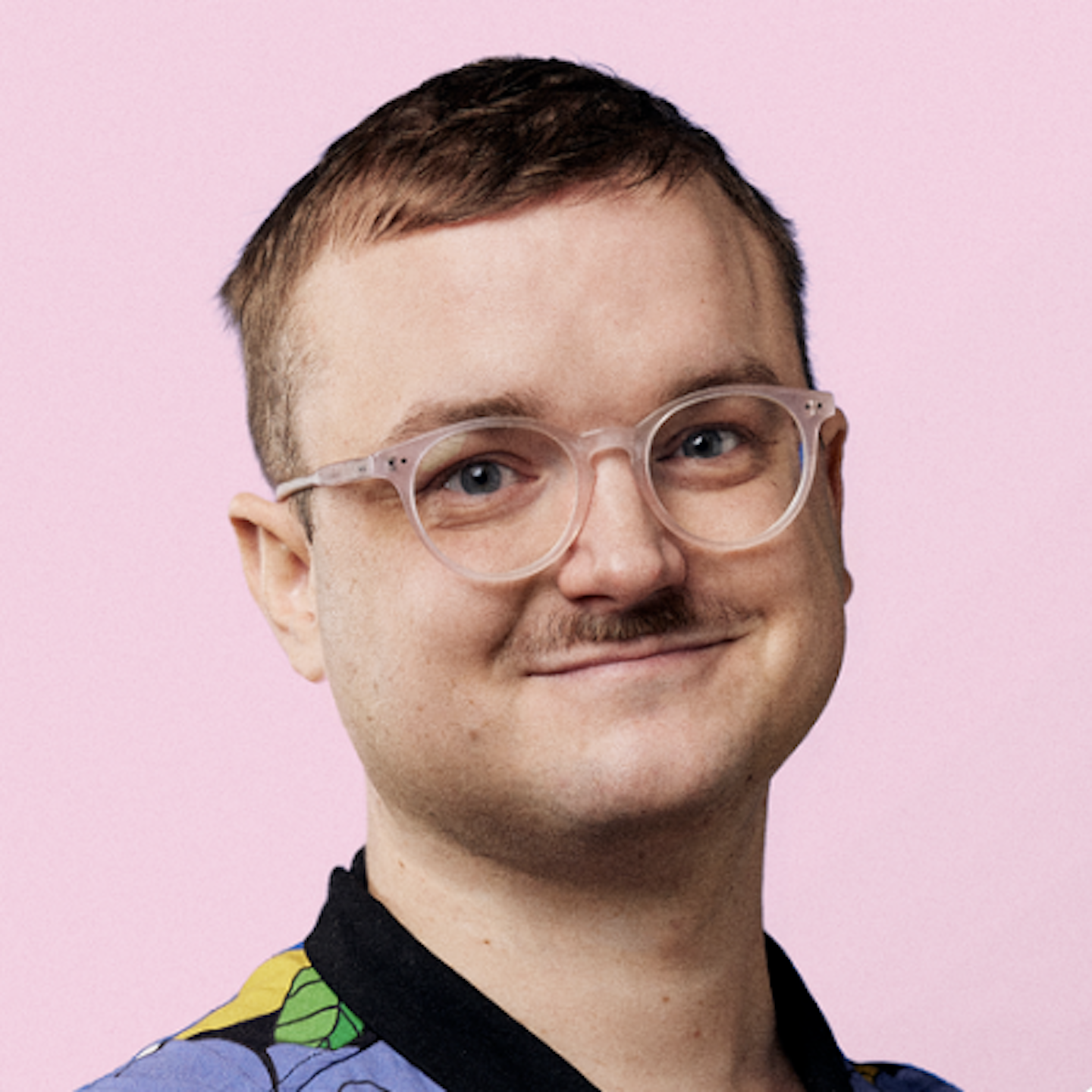 beautiful man with moustache and glasses in colorful shirt