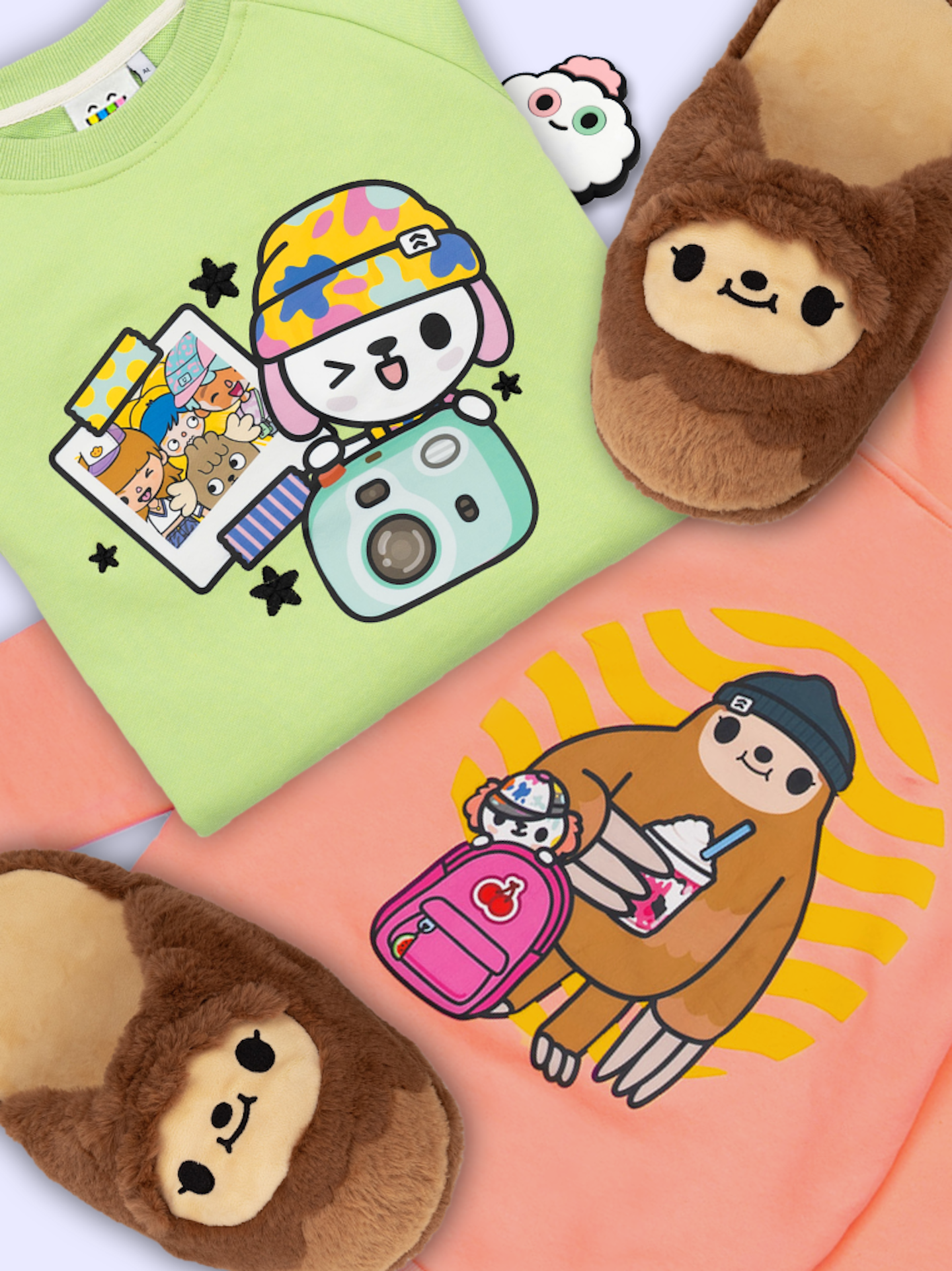 This is an image highlighting some of the real life Toca Boca merch that is available. There is a folded green sweater in the top left with a winking crumpet and other characters behind it in a polaroid and another orangey peach item of clothing in the bottom right with a sloth holding a shake and another crumpet poking out of a backpack. There are also slot slippers in the top right of the image and a white item of clothing with Croquet peeking out in the top middle of the image.