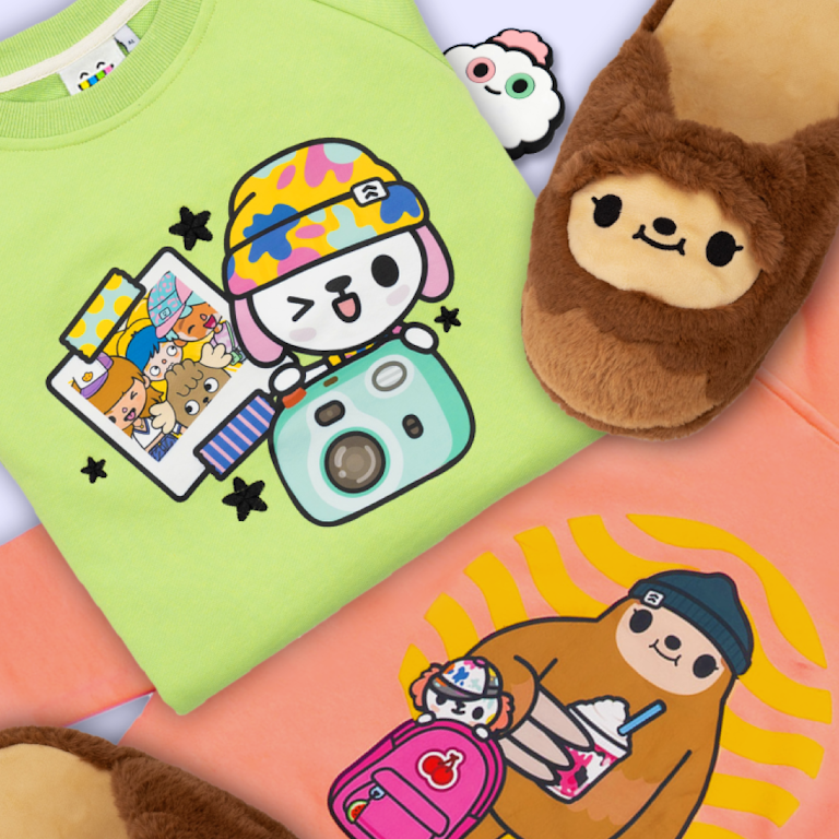 This is an image highlighting some of the real life Toca Boca merch that is available. There is a folded green sweater in the top left with a winking crumpet and other characters behind it in a polaroid and another orangey peach item of clothing in the bottom right with a sloth holding a shake and another crumpet poking out of a backpack. There are also slot slippers in the top right of the image and a white item of clothing with Croquet peeking out in the top middle of the image.