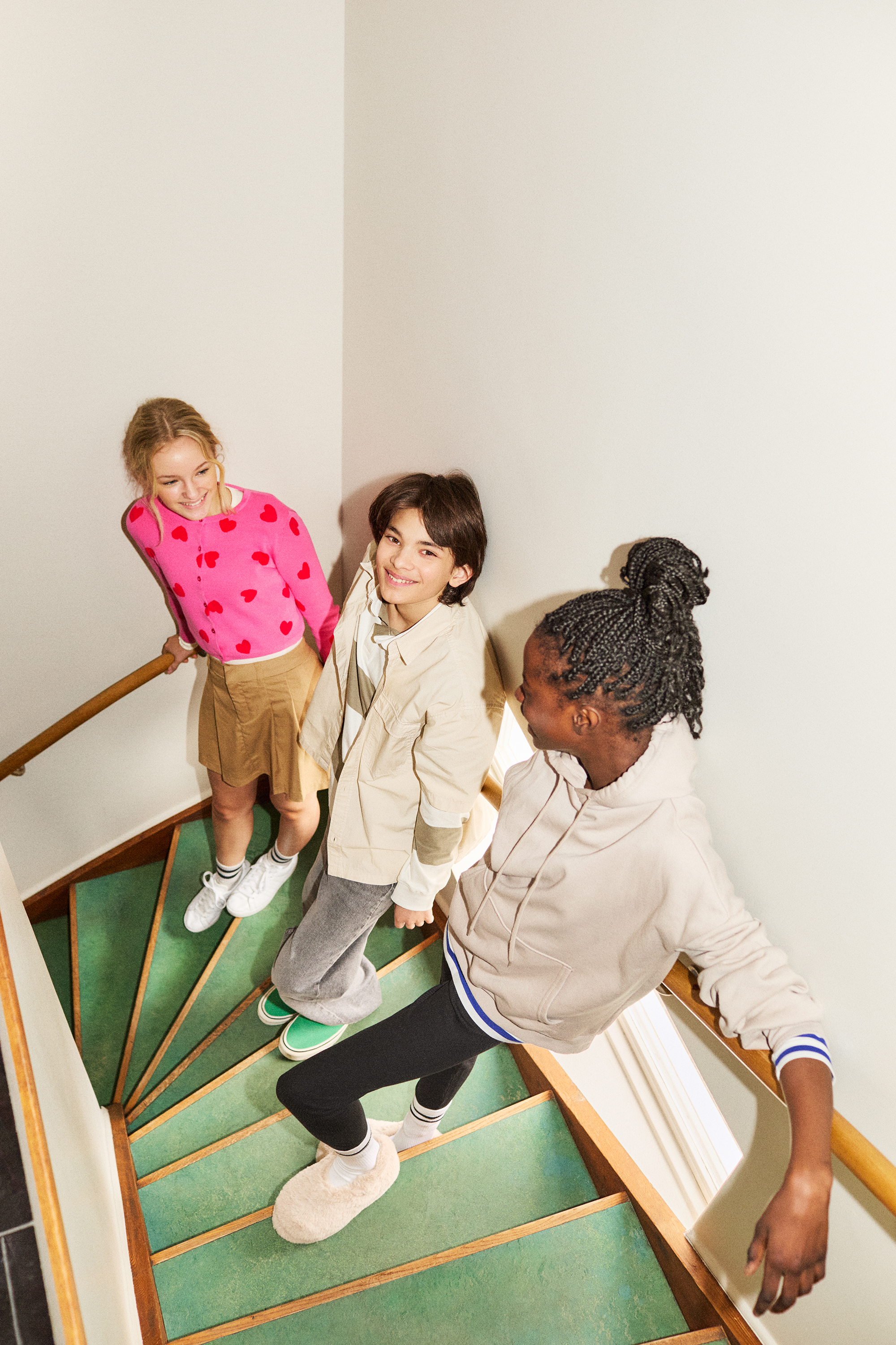 Tweens hanging out in a stair