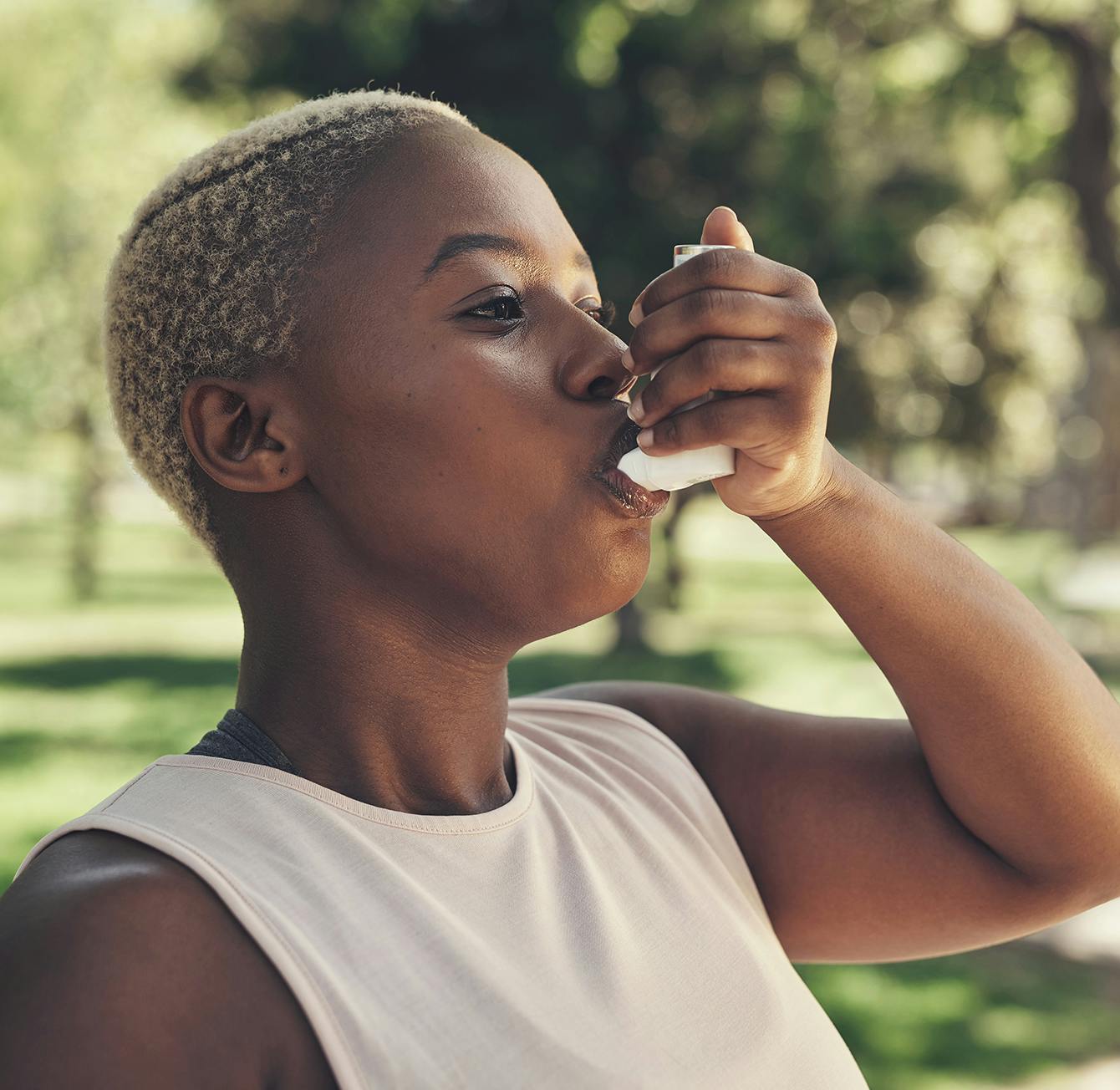 person using an inhaler