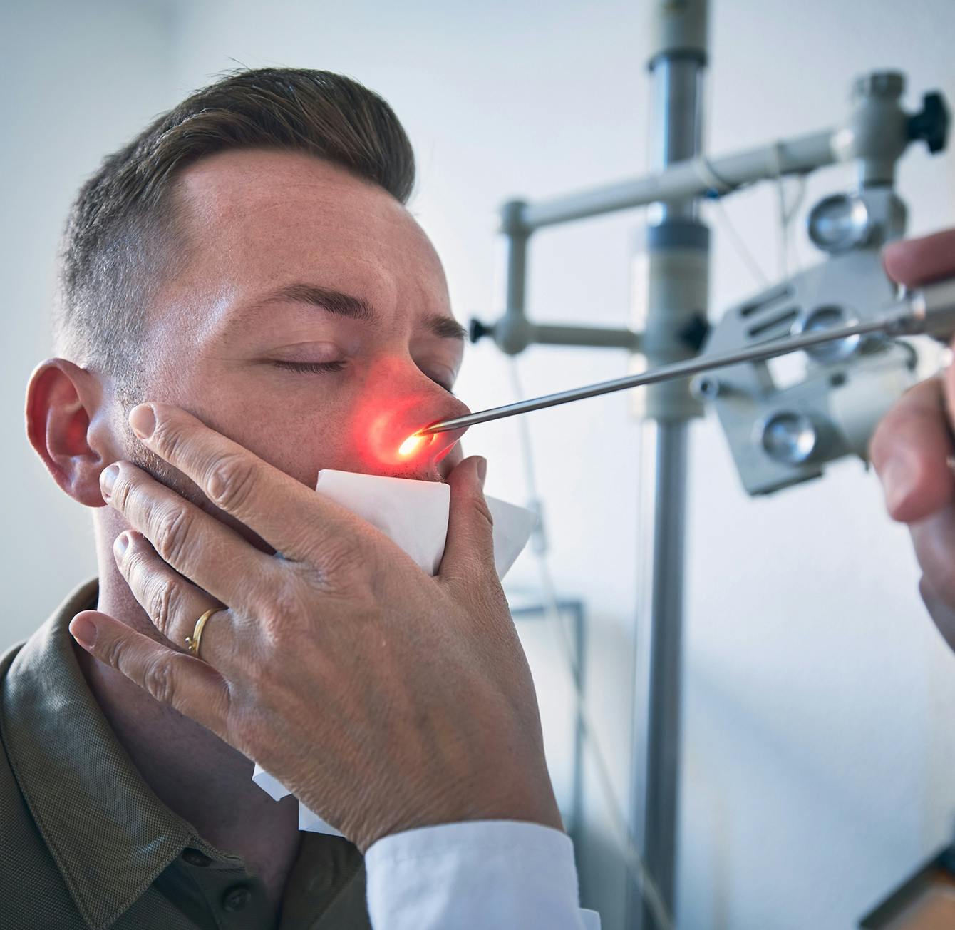 man having his nose examined